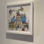 Welcome to My Town Print by Shanghee Shin on Display. The bent top right corner doesn't show inside this frame.